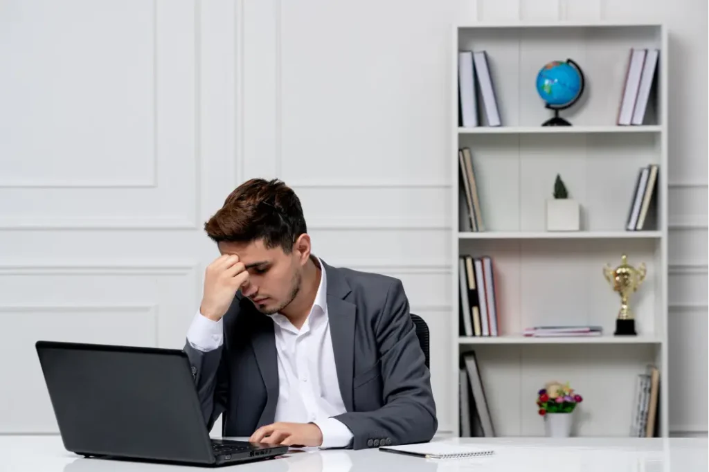 A man looking frustrated as his laptop is slow